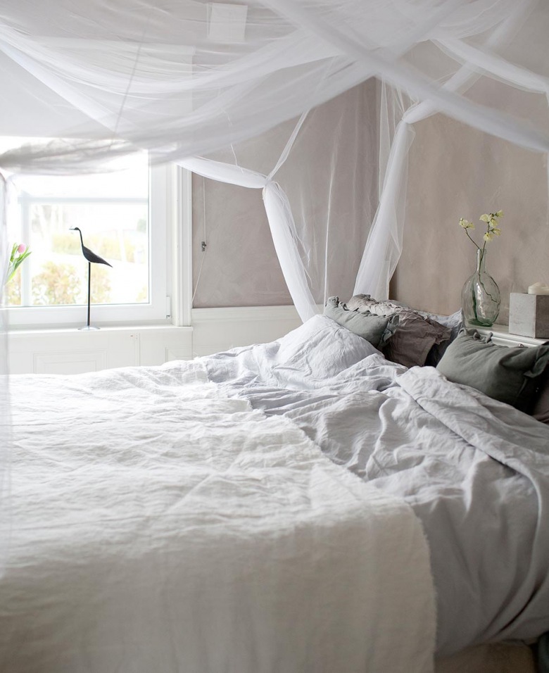Delikatnie udrapowany na kształt baldachimu tiul to przepiękna dekoracja tej wygodnej sypialni. Pościel i przykrycie na łóżku wydają się niezwykle miękkie i miłe w dotyku. Figurka czarnego, smukłego ptaka na parapecie okiennym to urocza...