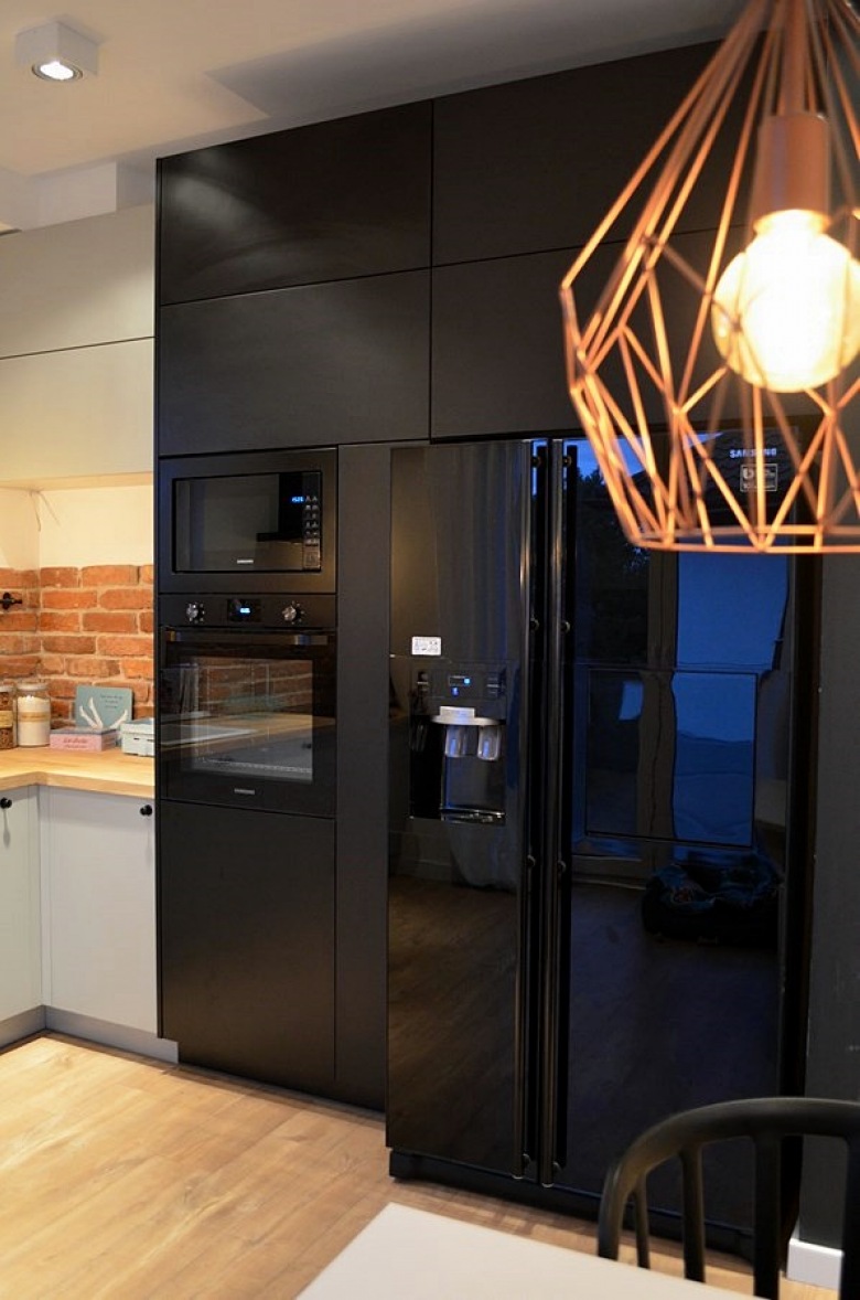 Czarna zabudowa kuchenna i czarna lodówka w kuchni (48059)