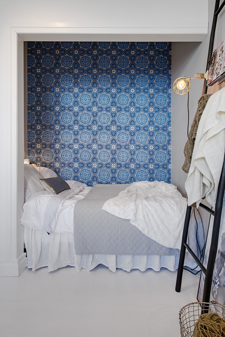 Łóżko we wnęce, czyli alkowa w skandynawskim stylu z  tapetą  z niebieskim ornamentem (22403)