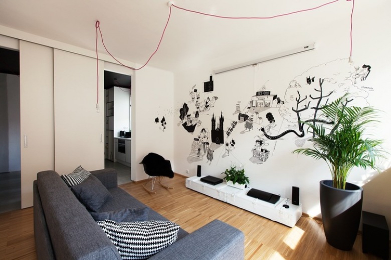 Nowoczesny salon z czarnymi grafikami, różowymi kablami z żarówkami i nowoczesnymi dodatkami (22277)