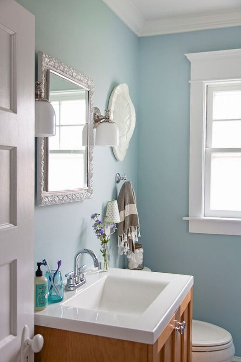 W małej łazience wykorzystano delikatne pastelowe odcienie, które wraz z eleganckimi dodatkami prezentują się bardzo gustownie. Jednym z ciekawszych elementów jest lustro w ozdobnej...