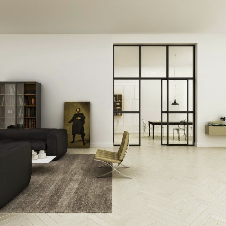 Metalowa i przeszklona ściana z drzwiami w aranzacji salonu z czarnymi sofami,szarym dywanem i miodowo-złotym nowoczesnym fotelem na metalowych nogach płozach (25722)