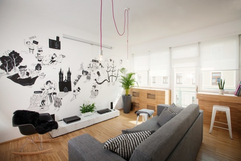 Szara sofa , czarne grafiki i różowe kable z żarówkami w aranżacji nowoczesnego salonu (22276)