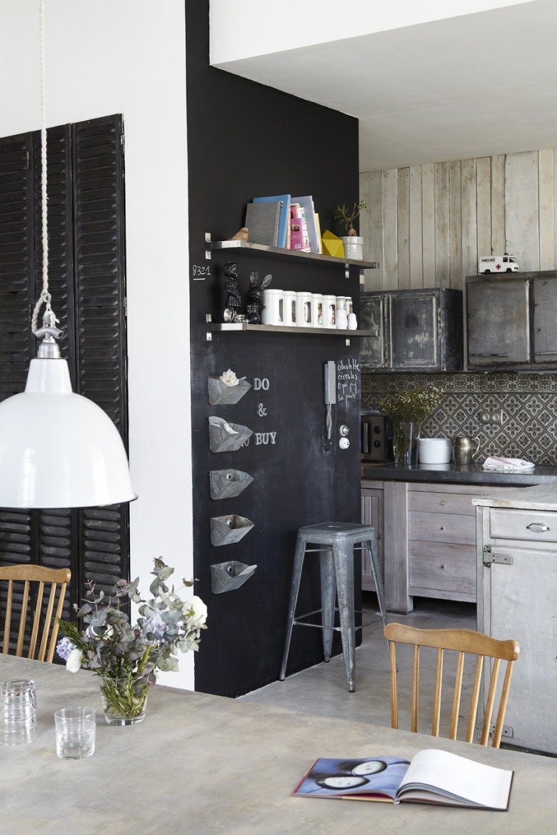 Czarna ściana, szare meble z drewna i metalowe lampy i stołki w kuchni (21103)