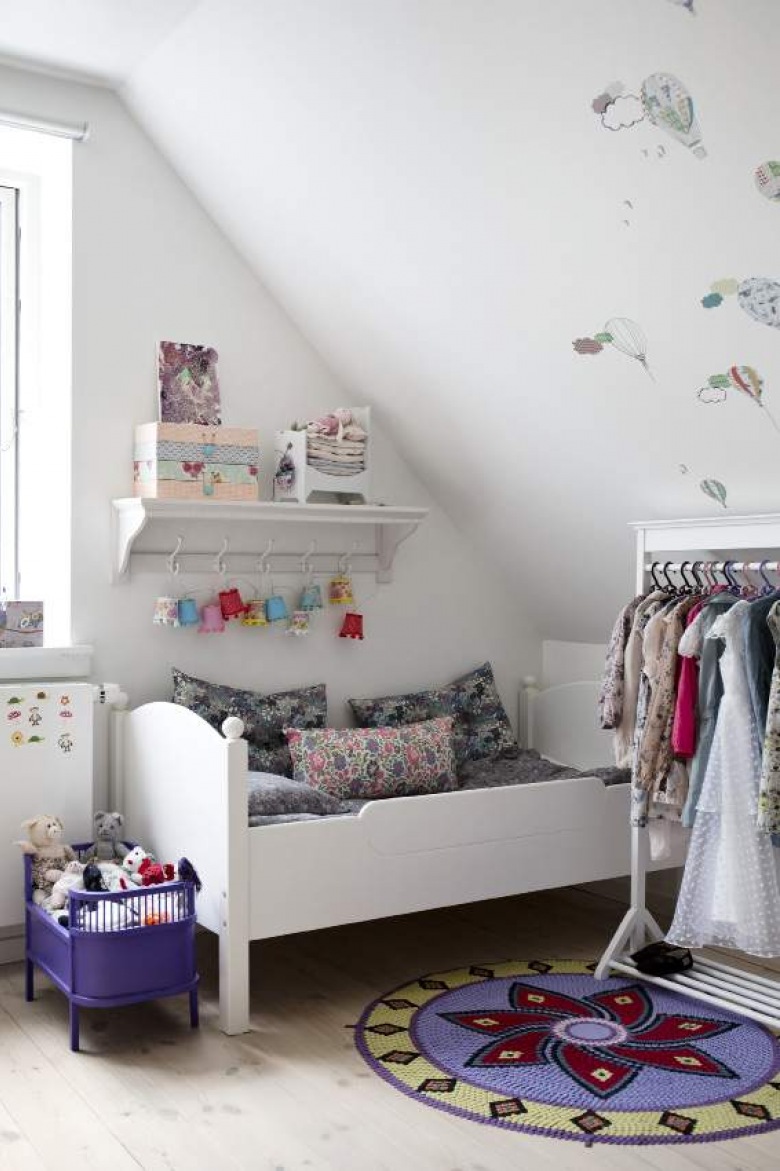 Dziergane dywaniki i drewniane łóżko w dziecięcym pokoju (21052)