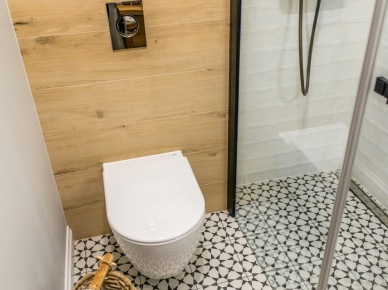Drewniana zabudowa i wzorzysta podłoga w malutkiej łazience (56530)