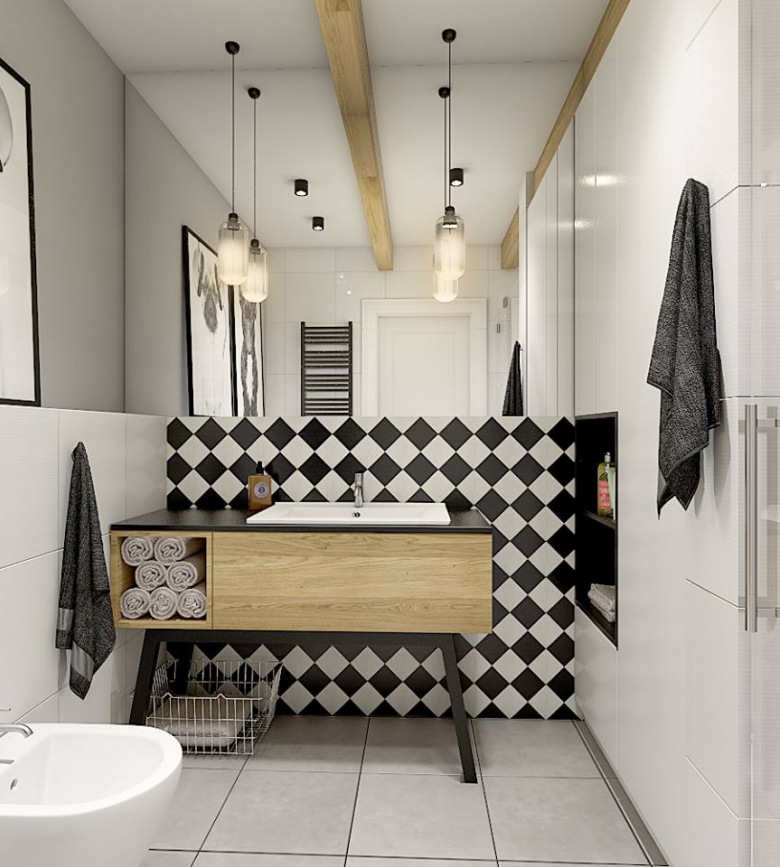 Czarno-biała aranżacja nietypowej łazienki, gdzie dominującym motywem okazuje się ściana z geometrycznym wzorem. Duże...