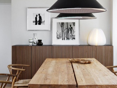 Drewniany gruby blat i metalowe podpory w industrialnym stole w jadalni z czarnymi stożkowymi lampami , giętymi krzesłami z drewna i juty i drewnianymi nowoczesnymi komodami z drewna (27623)