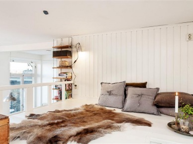 Futrzak i bawełniane poduszki w szarym i brązowym kolorze w białej sypialni (21253)