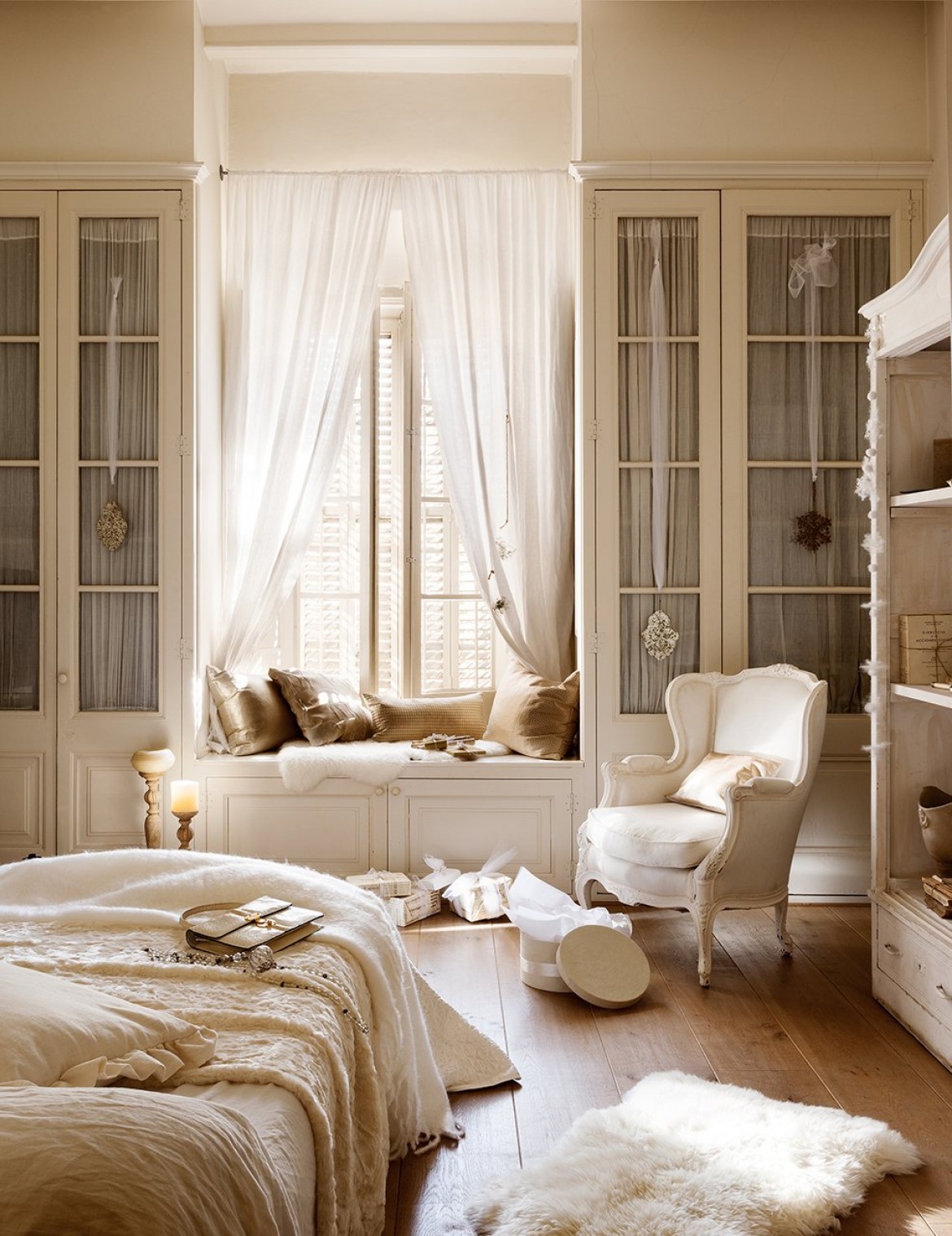Prowansalska pastelowa sypialnia z fotelem, zabudowanymi przeszklonymi szafami i siedziskiem przy oknie (27349)