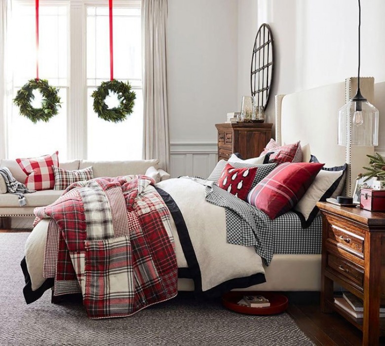 W sypialni właściciele stworzyli świąteczny klimat za pomocą pościeli. Kołdra i poduszki oraz pled w kolorach czerwieni...