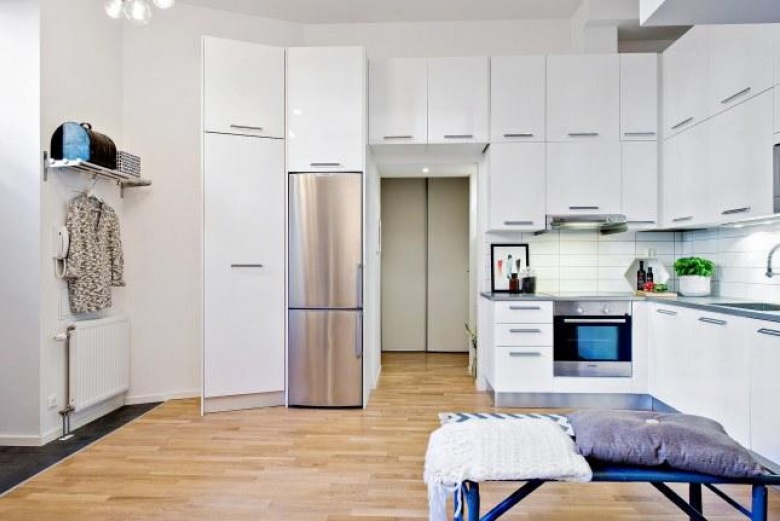 Wysokość mieszkania pozwoliła na zabudowanie kuchni pojemnymi szafkami niemal pod sam sufit. Pomagają zorganizować przestrzeń i ułatwiają przechowywanie kuchennych...
