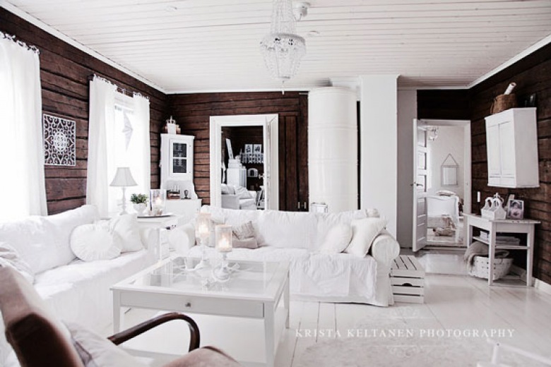 estetyczne i kunsztowne wnętrze salonu - elegancki kontrast brązu ścian i bieli mebli i podłogi.