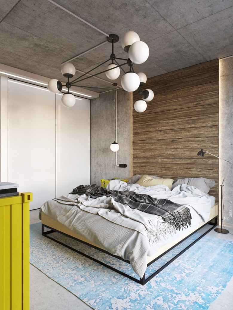 Po lewej stronie łóżka wnękę zabudowano szafą, nad którą umieszczono nowoczesne podświetlenie. W sypialni wyróżnia się oryginalny żyrandol oraz żółte...